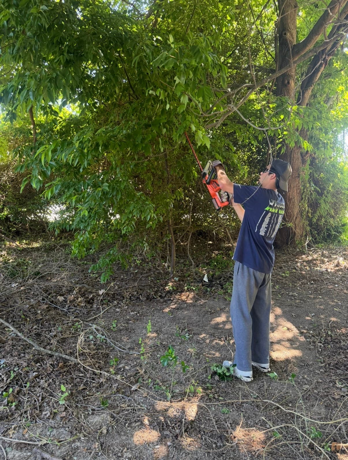 Shore Works crew member clearing brush on a Kent Island property